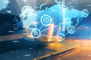 Computer on desktop with social network hologram. Multi exposure. Concept of international people connections.