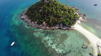 Fototapeta na wymiar Calm colorful azure turquoise sea near tiny tropical volcanic island Koh Tao, unique small paradise Nang Yuan. Drone view of peaceful water near stony shore and green jungle on sunny day in Thailand.