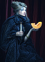 Fototapeta premium Gothic portrait of woman with candle.
