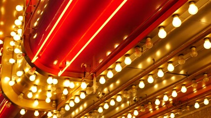 Old fasioned electric lamps blinking and glowing at night. Abstract close up of retro casino decoration shimmering in Las Vegas, USA. Illuminated vintage style bulbs glittering on Freemont street