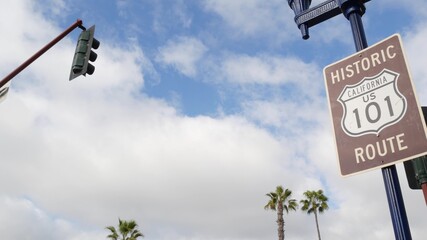 Pacific Coast Highway, historic route 101 road sign, tourist destination in California USA. Lettering on intersection signpost. Symbol of summertime travel along the ocean. All-American scenic hwy