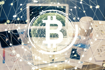 Double exposure of blockchain theme hologram and table with computer background. Concept of bitcoin crypto currency.