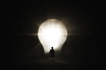 business man walks towards light bulb shape door