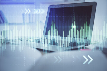 Stock market graph and table with computer background. Double exposure. Concept of financial analysis.