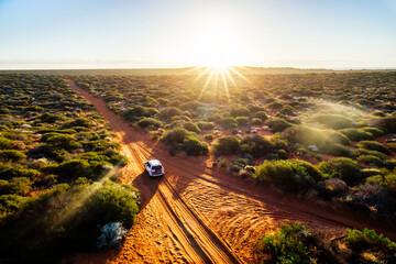 Australia, red sand unpaved road and 4x4 at sunset, freedom outback - 381846726