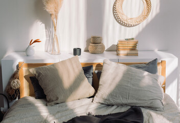 Cozy bedroom in Scandinavian style, shadows on the wall. Home decoration concept.