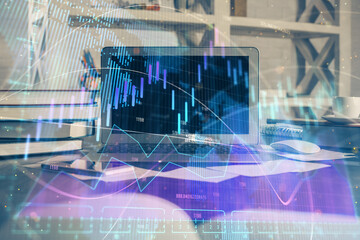 Financial chart drawing and table with computer on background. Multi exposure. Concept of international markets.