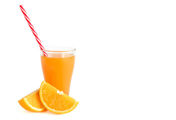 Glass of fresh orange juice with a straw with fresh orange slices cut in half on a white background with copy space, banner