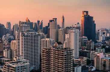 Fototapeta na wymiar Skyscrapers and Modern Buildings in Bangkok Downtown, Thailand at Sunset