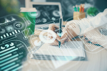 Tech theme hologram over woman's hands taking notes background. Concept of hightech. Double exposure