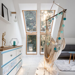 Stylish attic room with hammock seat