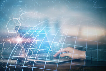 Multi exposure of world map hologram with man working on computer on background. Concept of worldwideweb.
