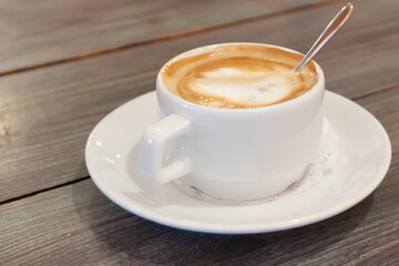 mug from a cappuccino on a wooden table