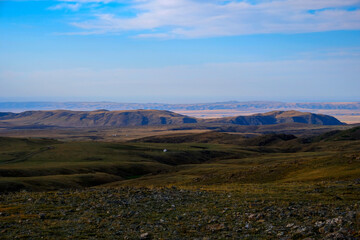 Colorful hills landscape in evening time with clouds background.