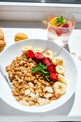 Healthy breakfast bowl on white table in hard lights