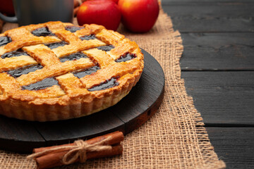 Close up of homemade traditional sweet autumn raspberry tart pie on wooden table