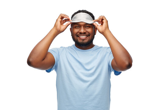 People, Bedtime And Rest Concept - Happy African American Man With Eye Sleeping Mask Over White Background