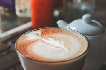 Hot coffee cappuccino with latte art in morning.