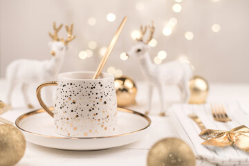 Beautiful composition with white Cup with the gold new year's drink
