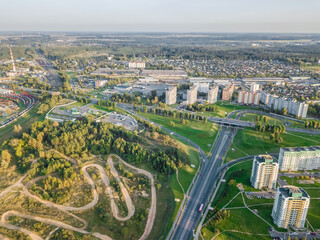 Aerial photography of the city with intersections, roads, houses, buildings, parks and Parking lots on a Sunny day