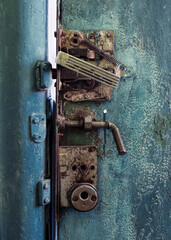 Strange and complicated lock of an old rusty metal door