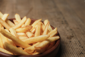 french fries on wooden background