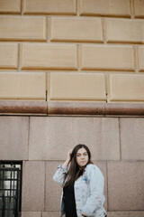 Portrait of a beautiful young woman with natural light outdoors in the city