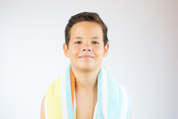 Little boy kid wearing swimsuit and towel going to the beach