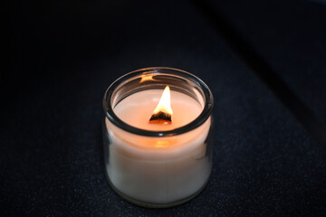 burning candles with wooden wick