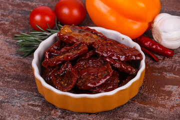 Dried tomatoes in the bowl with olive oil