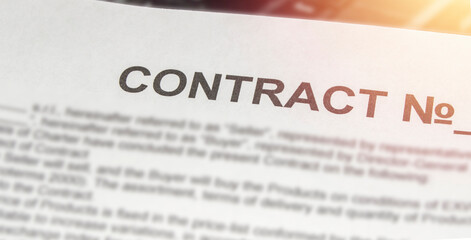 Obraz premium Business contract printed on a white sheet of paper and light in the corner, banner