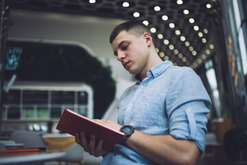 Focused man reading notes in planner