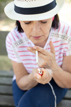 senior woman smoking cigarette close up