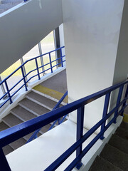 Flight of stairs. Stairs with blue metal railings