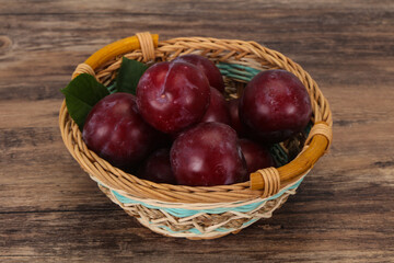 Plum heap in the wooden basket