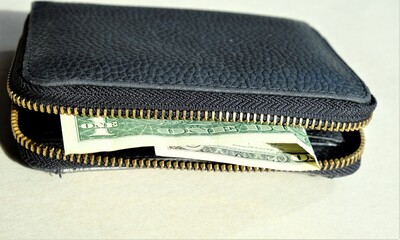 black leather wallet with one dollar in it