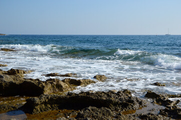 Fototapeta na wymiar rocky sea shore background in bright sunny day