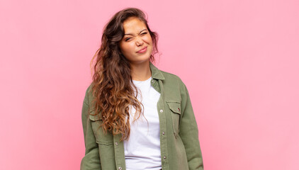  looking happy and friendly, smiling and winking an eye at you with a positive attitude