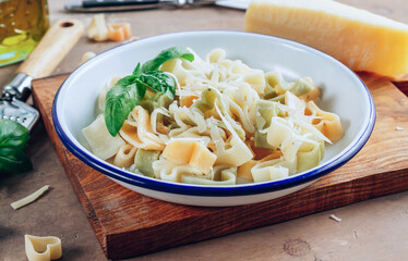 Heart-shaped pasta with basil leaves and parmesan