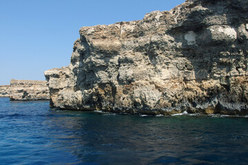 Fototapeta premium rocky coastline on Malta island with calm blue sea