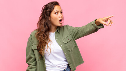  feeling shocked and surprised, pointing and looking upwards in awe with amazed, open-mouthed look