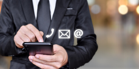 Businessman hand using mobile smartphone. Concept of Contact Us, customer support. copy space.