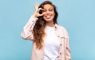  smiling happily with funny face, joking and looking through peephole, spying on secrets