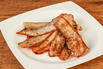 Roasted juicy bacon in the plate