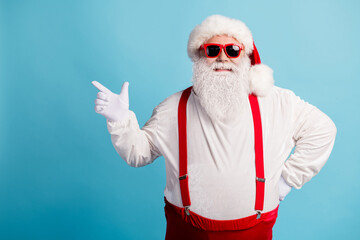Fototapeta na wymiar Portrait of his he nice attractive cheerful cheery content overweight white-haired Santa demonstrating copy space advert ad isolated over bright vivid shine vibrant blue color background