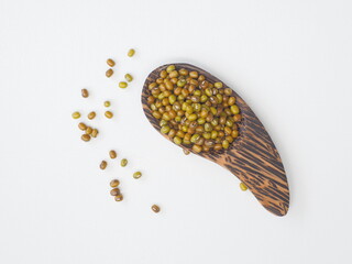 Mung bean, Green moong dal in wooden spoon on white wooden background.