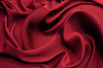 Beautiful draped wool fabric. Red fabric for decoration with decorative folds. Background and...