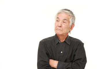 senior Japanese man thinks about something
