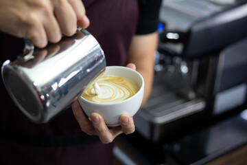 Close-up of Man Barista making latte art