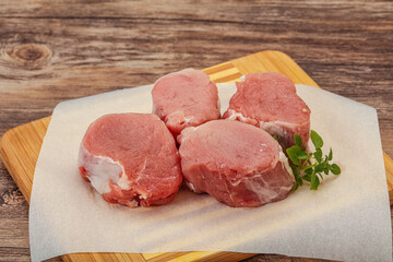 Raw pork medallion served rosemary